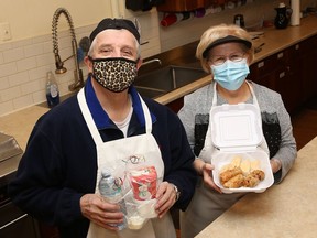 Michael Gawalko and Louise Halushenski display one of 55 lunches that will be delivered to seniors in Greater Sudbury this week. St. Mary's Ukrainian Catholic Church had a curbside Christmas luncheon recently and offered customers the opportunity to gift a meal to a senior by purchasing an extra meal for an elder. Volunteers from St. Mary's and St. Michael's Ukrainian Catholic Church will deliver the meals.