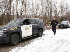 OPP officers investigate the discovery of a body off Tilton Lake Road near Long Lake last Wednesday.