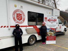 The Sally Ann's emergency response truck, from which take-out Christmas dinner will be served in OSHaRe's parking lot Dec. 25, 2020 in Owen Sound, Ont. Left, Salvation Army family services director Alice Wannan, with OSHaRE executive director Colleen Trask Seaman. (Supplied to The Sun Times/Postmedia Network)