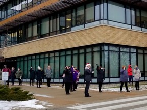 A surprise parade involving police, firefighters, paramedics and others was a show of appreciation for people's work amid the COVID-19 pandemic. Here it passes waving staff at Grey Bruce Health Unit, one of 18 stops Thursday Dec. 17, 2020 in Owen Sound, Ont. (Scott Dunn/The Sun Times/Postmedia Network)