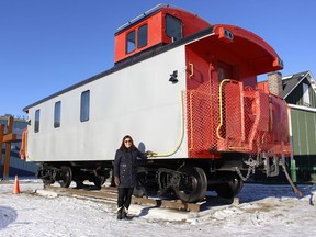 Monica Towsley, program coordinator with the Timmins Museum, stands next to the museum's newest outdoor exhibit: An old T&NO railway caboose. Like the old Hollinger House that it has been placed next to, it will be opened to the public at some point and people will be able to tour through it.

RICHA BHOSALE/The Daily Press