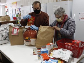 Peter Davis, treasurer for the South Porcupine Food Bank, and volunteer Connie Grosvenor, were preparing some grocery bags for their client families on Friday.

RICHA BHOSALE/The Daily Press