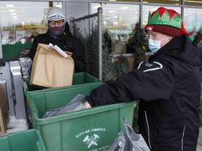 Anti-Hunger Coalition Timmins' volunteers Michael Thoerner, left, and Justin Rowberry were out collecting cash donations and non-perishable food items outside Food Basics on Friday for the annual "Ton in a Tundra." The donations will be used to fill Christmas Food Boxes for families in need. The event was held at a half a dozen business outlets across the city.

RICHA BHOSALE/The Daily Press