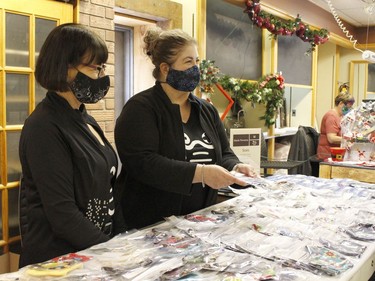 Holly Morissette, left, was helping out her friend and owner of the Mask Persona, Heather Ferguson,while serving customers at their booth at the holiday pop-up shop on Saturday.

RICHA BHOSALE/The Daily Press