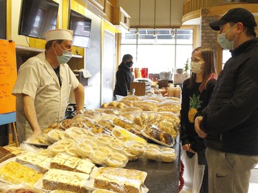 Michel Pouliot, left, was selling fresh bread and pastry products during the holiday pop-up shop in Saturday. He is seen here chatting with customers Jason Rockel and his daughter Naomi.

RICHA BHOSALE/The Daily Press