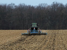 A dedicated farmer in Norwich Township continues to work on his fields earlier this week, despite the colder weather having signalled the coming winter weather. (Greg Colgan/Postmedia Network)