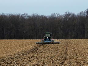 A dedicated farmer in Norwich Township continues to work on his fields earlier this week, despite the colder weather having signalled the coming winter weather. (Greg Colgan/Postmedia Network)