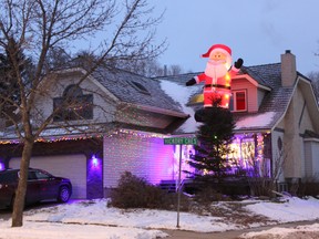 An inflatable Santa sits atop a home in Heritage Hills. Travis Dosser/News Staff