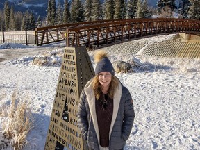 Lesley Russell, artist and senior designer partner at Russell and Russell Design Studios stands by her public art installation called Avens beside Cougar Creek. photo by Pam Doyle/www.pamdoylephoto.com