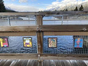 Twenty different linoprinted canvas flags hanging on the pedestrian bridge over Cougar Creek. The flags were created on the fall of 2020 by a diverse collection of community members in the Cougar Creek neighborhood funded through a Town of Canmore grant, conceived and coordinated by local artist Fonda Sparks. Participants learned linoprinting for the first time and created engaging works of art showcasing what each person and their family is passionate about. Photo Marie Conboy/ Postmedia.