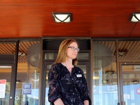 Susan Rowe, Quinte Health Care's vice-president of people and strategy, stands outside Belleville General Hospital's closed main entrance in August. She said Thursday patients who need hospital care should go to the hospital; some of those who have delayed care are now being seen in worse condition.