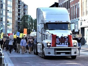 Led by a police escort and a large tractor trailer, participants chanted as they made their way through Belleville's downtown toward City Hall in a Black Lives Matter demonstration in July. VIRGINIA CLINTON Postmedia Network FILE