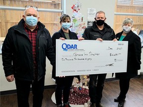 Ron Crisp and Christine Wollerman, from Grace Inn Shelter, accept a cheque for $6,680 from Don McColl and Heather Plane from the Quinte & District Association of REALTORS¨ REALTOR¨ campaign. SUBMITTED PHOTO