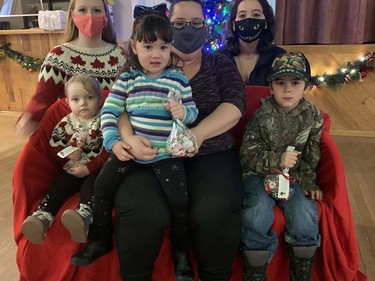 Octavia Elliott (left), 2, Faith Townson-Lee, 2, and Domenic Hey, 4, accompany Lina Spiece (back, leftt), Kimberlyn Townson, 25, and  Chrysta Townson, 24, to Breakfast with Santa at the Polish Hall on Pearl Street on Sunday morning. Vincent Ball