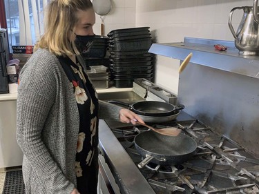 Taylor Cross, a past International Villages ambassador for the Polish Hall on Pearl Street, flips a pancake at the hall on Sunday preparation for Breakfast with Santa. She was one of many volunteers who helped deliver some Christmas cheer to local children and their families. Vincent Ball