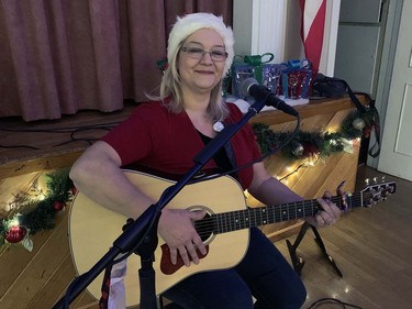 Monique Hunsley provides Christmas music for'Breakfast with Santa at the Polish Hall on Pearl Street on Sunday morning. Vincent Ball