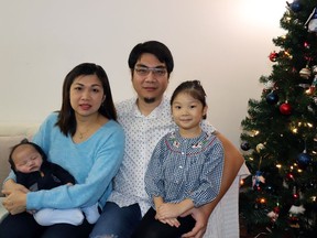 Daniel Muljarahardja and Saraswati Djojorahardjo,  pose with their daughter, Madeline, and infant son Marcellinus. He needs medical treatment that is available at a high cost in the United States.