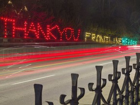 A message thanking frontline workers is spelled out with Christmas lights at a Paris home opposite the Penmarvian retirement home on Grand River Street North. Brian Thompson
