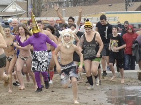 People take part in the Polar Bear Plunge in Port Dover on New Year's Day 2019. People are being discouraged from gathering for dip in Lake Erie on Friday.