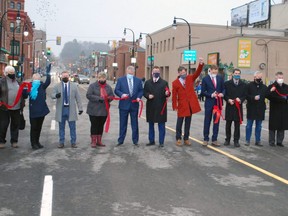 Local politicians and members of the city's operations committee and Downtown Improvement Area board cut the ribbon to officially open Owen Sound's new 10th Street bridge Friday afternoon. DENIS LANGLOIS