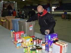 Kinsmen Club of Prescott member Art Hitsman and other volunteers unload barrels, boxes and bags filled with non-perishable food items at the Leo Boivin Community Centre. The donated items will be added to the Spirit of Giving Christmas hampers that will be distributed to households in Augusta, Edwardsburgh Cardinal and Prescott on Dec. 19. Cash donations will be collected at O'Reilly's Your Independent Grocer on Friday, Saturday and Sunday.
Tim Ruhnke/The Recorder and Times