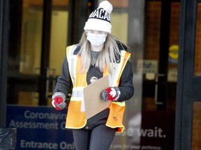 Sidney Ham, a worker at Brockville's COVID-19 assessment centre, prepares to do intake on new arrivals on a busy afternoon on Dec. 21. (RONALD ZAJAC/The Recorder and Times)