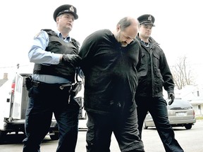 Ronnie Inghelbrecht has been sentenced to five years in jail after pleading guilty on Monday to historical sexual assaults that involved four young victims at the time. He is seen in this file photo from November 2012 as Chatham-Kent police special constables John Carter, left,  and Tyler Bergsma, right, escort him to the local jail after he was sentenced to five years for sexual assault and two years for possession of child pornography. (Postmedia file photo)