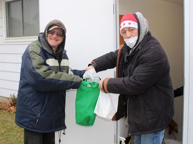 John Gander, left, picks up a take-out lunch from volunteer Ralph La Bonte at the Campbell AME Church soup kitchen in Chatham on Wednesday. Ellwood Shreve/Chatham Daily News/Postmedia Network