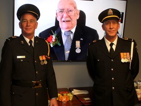 Len Langlois, seen in this video link, is pictured with his sons Ken Langlois, left, and Kevin Langlois, both paramedics, after receiving the Governor General's EMS Exemplary Services Award Medal 3rd bar, which represents 50 years of service, during a ceremony held at the Doug Arbor EMS Headquarters in Chatham on Monday. (Ellwood Shreve/Chatham Daily News)