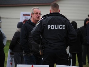 MPP Randy Hillier chats with a CPS officer before the start of the Cornwall March for Freedom. Photo on Saturday, November 21, 2020, in Cornwall, Ont. Todd Hambleton/Cornwall Standard-Freeholder/Postmedia Network
