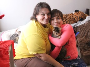 Amanda Craig and her 10-year-old daughter Angellica, on the futon just inside the front door at the small apartment they just moved into. Photo on Thursday, Dec. 17, 2020, in Cornwall, Ont. Todd Hambleton/Cornwall Standard-Freeholder/Postmedia Network