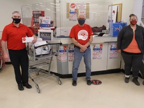 From left at the 2020 Celebration Sleigh raffle draw at Baxtrom's Your Independent Grocer are John Baxtrom, United Way volunteer Stephen Douris, and United Way communications co-ordinator Stephanie Lapointe. Photo on Friday, Dec. 18, 2020, in Cornwall, Ont. Todd Hambleton/Cornwall Standard-Freeholder/Postmedia Network