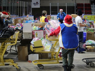 Terry Muir (facing camera) and volunteers at the food and toy staging area at the ChildrenÕs Christmas Fund delivery event at the civic complex. Photo  on Friday, Dec. 18, 2020,  in Cornwall, Ont. Todd Hambleton/Cornwall Standard-Freeholder/Postmedia Network