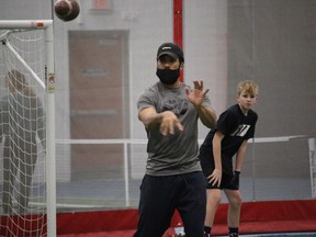 Coach Nate Behar tosses a pass at the Formula 11 Cornwall Wildcats camp. Photo on Sunday, December 20, 2020,  in Cornwall, Ont. Todd Hambleton/Cornwall Standard-Freeholder/Postmedia Network