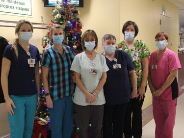 Staff from the nursing station area, at one of several decorated trees in the hospital. Photo on Tuesday, December 22, 2020, in Alexandria, Ont. Todd Hambleton/Cornwall Standard-Freeholder/Postmedia Network