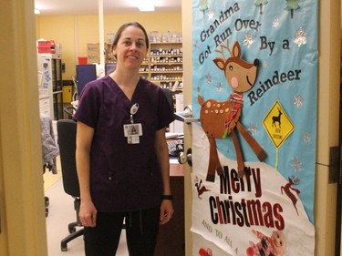 Pharmacy technician Sophie Curotte-Derouchie at a festively-decorated entrance. Photo on Tuesday, December 22, 2020, in Alexandria, Ont. Todd Hambleton/Cornwall Standard-Freeholder/Postmedia Network