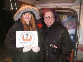 Two key members of Project Phoenix - Phoenix Scott and her mom Julie Corneman, during a recent visit to Cornwall, with supplies in the back of their minivan. Photo in Cornwall, Ont. Todd Hambleton/Cornwall Standard-Freeholder/Postmedia Network