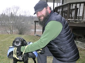 Randy Finlayson and Coco, his constant companion, pose outside their Mitchell home before venturing out for a walk. Like most dog owners, the walk is for exercise for both participants, but Randy and Coco also pick up garbage they encounter on their travels. ANDY BADER/MITCHELL ADVOCATE