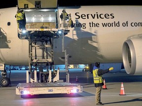 Canada's first batch of Pfizer/BioNTEch COVID-19 vaccines is unloaded from a UPS cargo plane at Montreal-Mirabel International Airport in Montreal on December 13, 2020. PHOTO BY CPL MATTHEW TOWER/CANADIAN FORCES