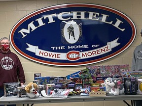 Rev. Will Kramer (left), and captain Luken Van Pelt represented the Mitchell Hawks' players, hockey operations and executive Dec. 9 as they came together to give back to the community and donated toys and $500 in cash to the Christmas Community Care Fund, all in an attempt to help make some local children's Christmas better. SUBMITTED