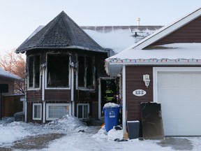 Investigators from Regional Emergency Services inspect the site of a house fire on Boisvert Place in Fort Mcmurray on Dec. 21, 2020. Sarah Williscraft/Fort McMurray Today/Postmedia Network