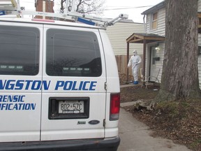 A Kingston Police forensics officer walks out of the residence at 142 Pine St. as the investigation into the fatal stabbing of two people on Saturday nigh continued on Dec. 14.