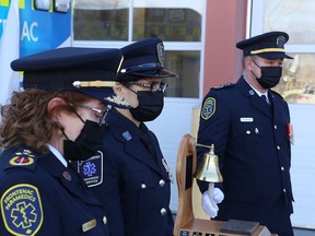 Frontenac Paramedics Chief Gale Chevalier, left, advanced care paramedic Julie Socha and superintendent Michael van Hartingsveldt read the names of 51 paramedics killed in the line of duty during a ceremony Tuesday morning marking the arrival of the Paramedics Memorial Bell in Kingston.