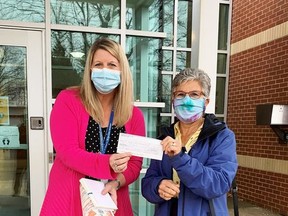 Principal Brenda Reil of St. Joseph Catholic School accepts a cheque for $500 from Lions Club member Debra Donaldson. The donation will help purchase pre-packaged food to give to students at the start of the day. Supplied by Susan Tunnicliffe