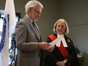 North Frontenac Township Mayor Ron Higgins, pictured being sworn in by Justice Anne Trousdale as warden of Frontenac County council in 2018, floated a proposal to restructure municipal government into a single-tier municipality.