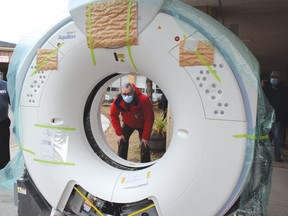 Photo by KEVIN McSHEFFREY/THE STANDARD
Pierre Ozolins, St. Joseph General Hospital CEO, looks through the CT scanner shortly after it arrived on Tuesday Dec. 8. It took more than three years of work by many people to get it in Elliot Lake. For the story, see page 6.