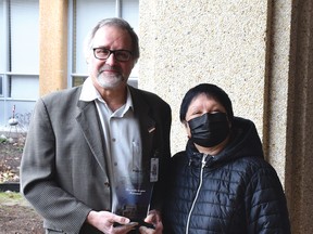 Photo by KEVIN McSHEFFREY/THE STANDARD
St. Joseph’s General Hospital CEO Pierre Ozolins accepts a gift from the hospital board chair Elaine Johnson in appreciation of all the work he has done. Ozolins retires in January.