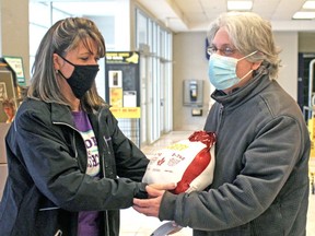 Jody Etmanski gives Ivan Pare a Christmas turkey as part of a Service Employees International Union campaign to help members through the holiday season.
PJ Wilson/The Nugget