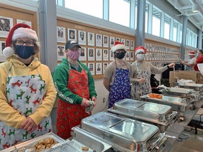 Volunteers dish out helpings of turkey, stuffing, mashed potatoes, vegetables and gravy, along with cranberry sauce. This year's Christmas Day dinner at Memorial Gardens distributed more than 500 turkey meals in less than four hours.
Jennifer Hamilton-McCharles, The Nugget