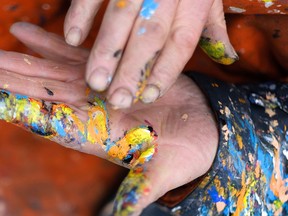 The hands of the artist, who used different colors and shades of paint

Not Released (NR)